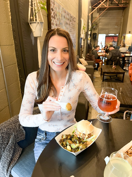 Christine with food and beer at Ginger's Revenge