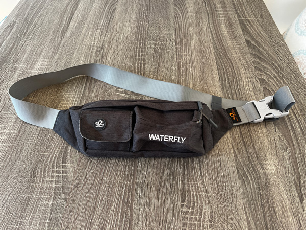 gray Waterfly Fanny Pack on light gray table