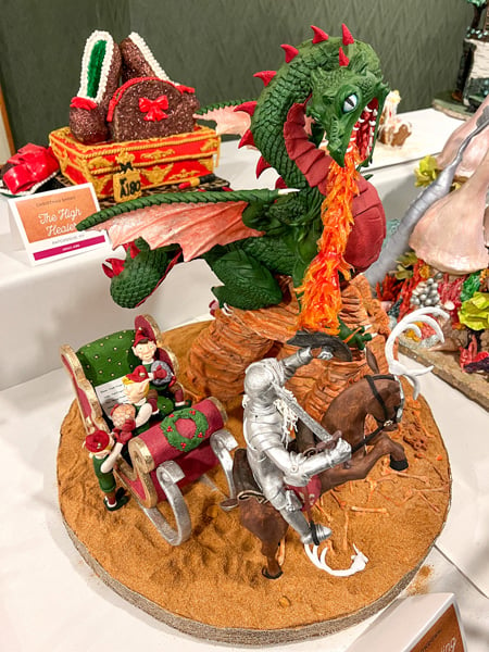 Green gingerbread dragon spouting fire and knight at the National Gingerbread House Competition in Asheville, NC
