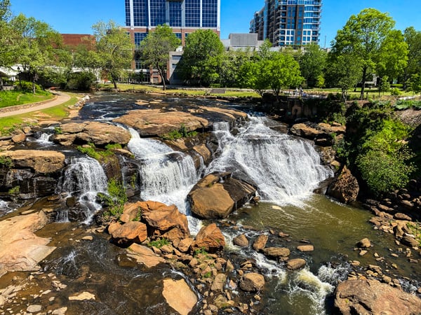 Falls Park on the Reedy (small waterfalls with Downtown business buildings in the background) in Greenville, South Carolina