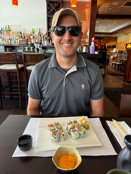 Tom eating Umi Sushi rolls