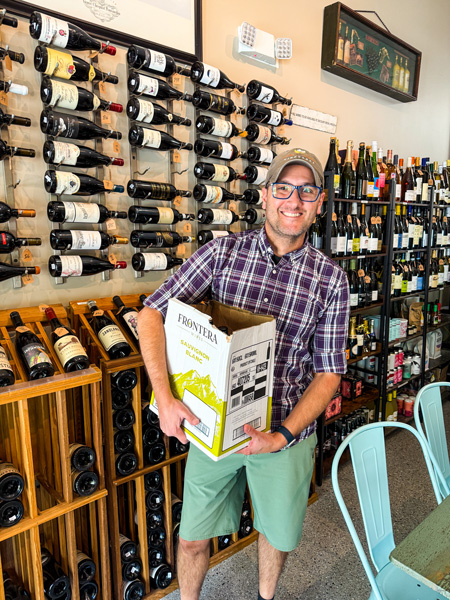 Tom buying wine at Quench