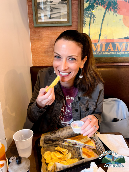 Christine eating a Cuban sandwich Cousins Cuban Cafe Black Mountain NC