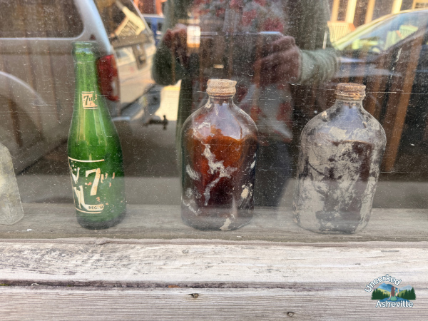 Marshall NC Helene Damage Storefront With Muddy Bottles