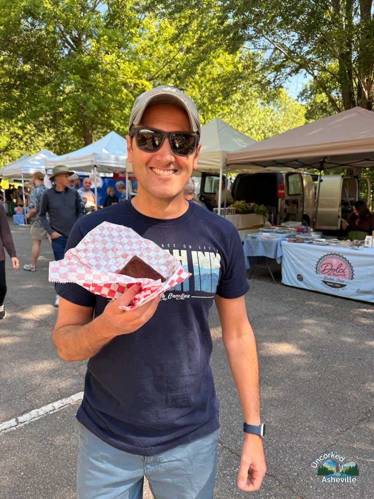 Tom eating Dolci di Maria vegan bar at North Asheville Tailgate Market